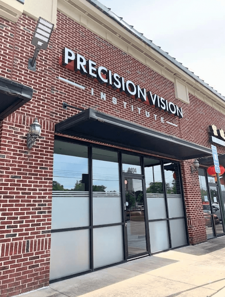 Precision Vision Institute's brick storefront with its white exterior sign at 3940 Buford Highway in Duluth